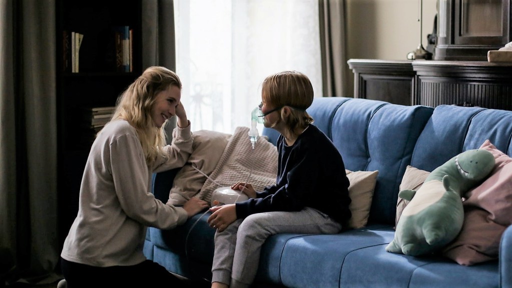 Mother creating a healing environment for child on couch