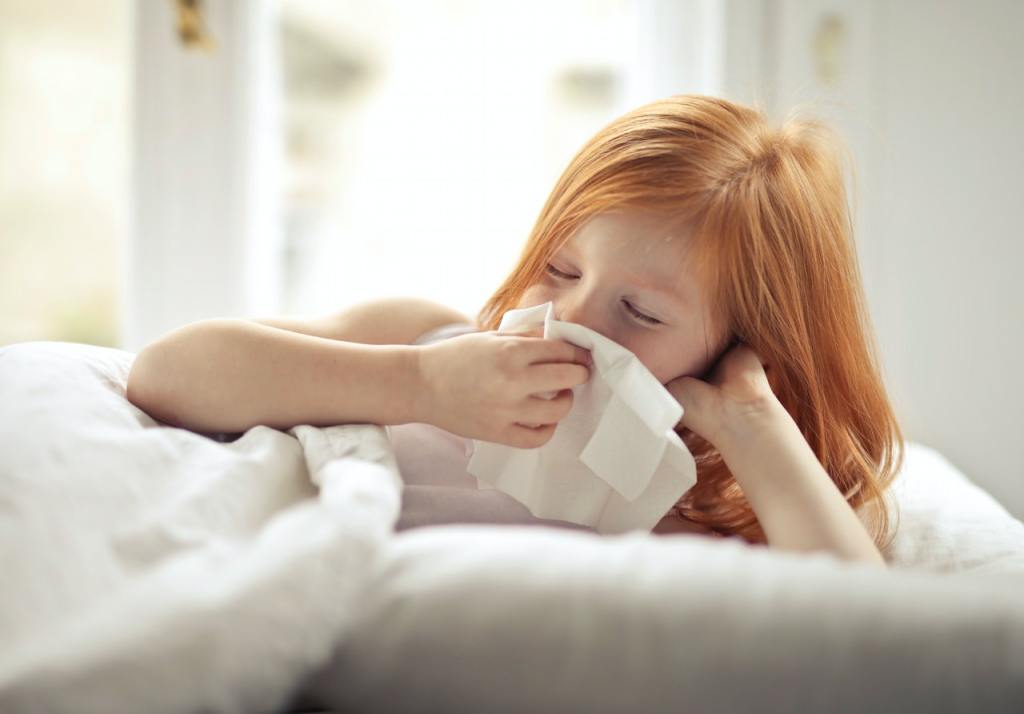 Girl blowing nose - needs a nasal saline flush