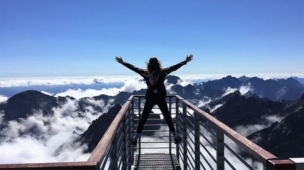 Woman reaching potential climbing mountain
