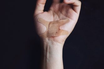 Wounded hand with a band-aid