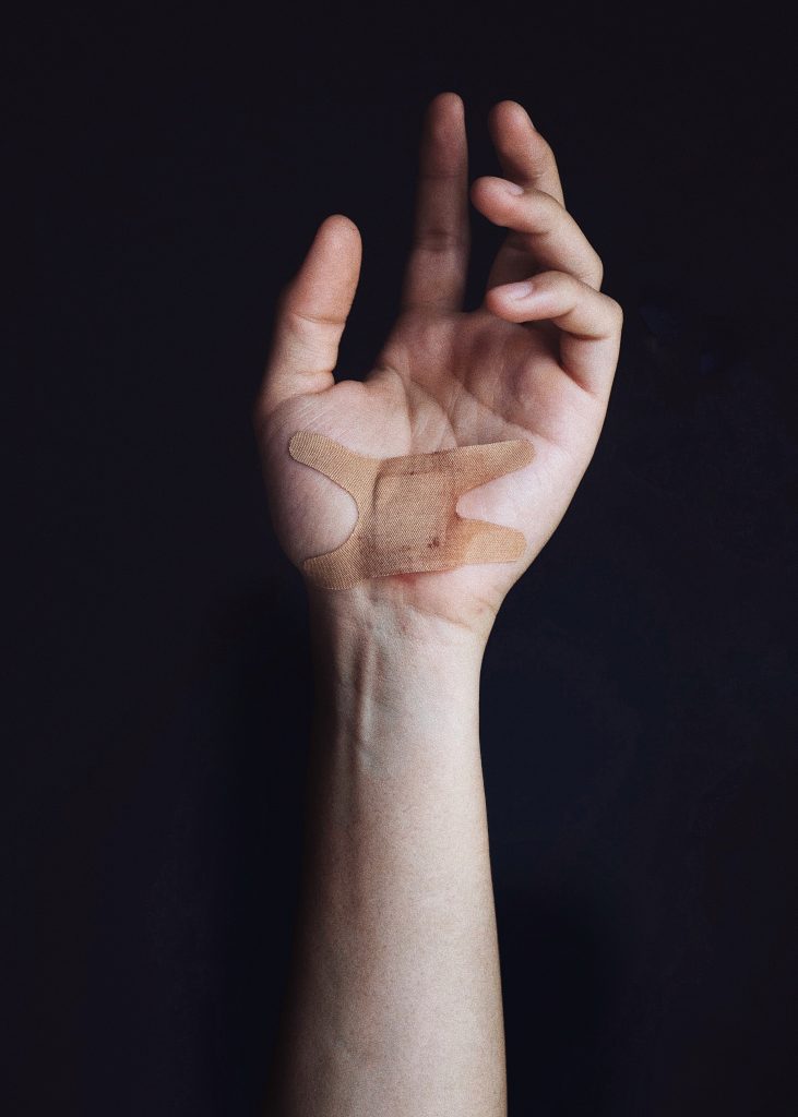 Wounded hand with a band-aid