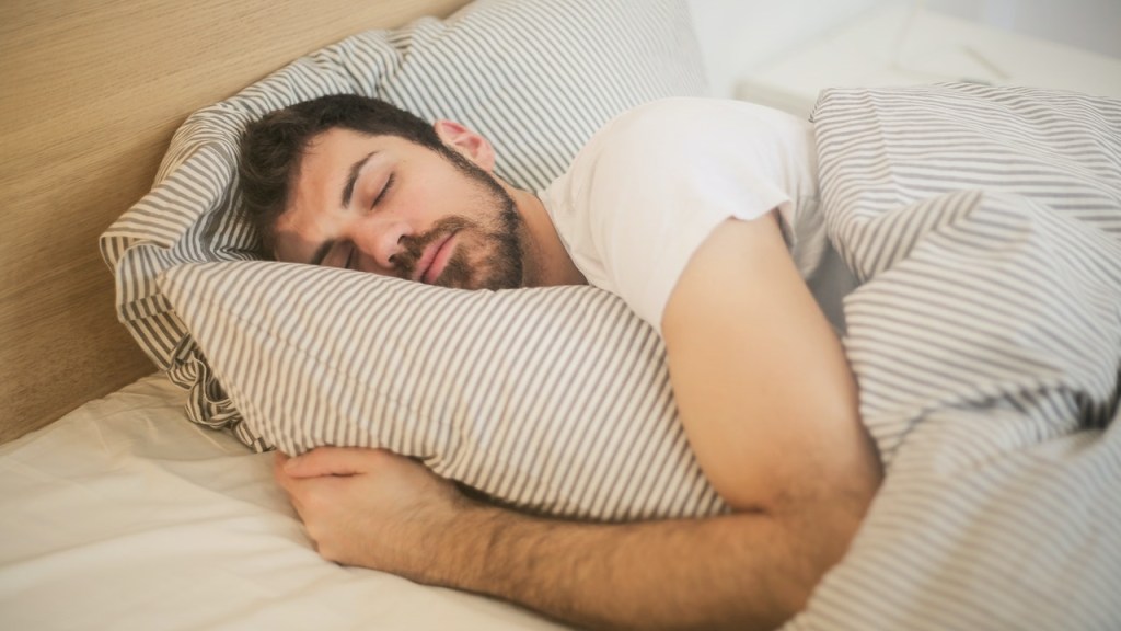 Man in bed getting a good night's sleep