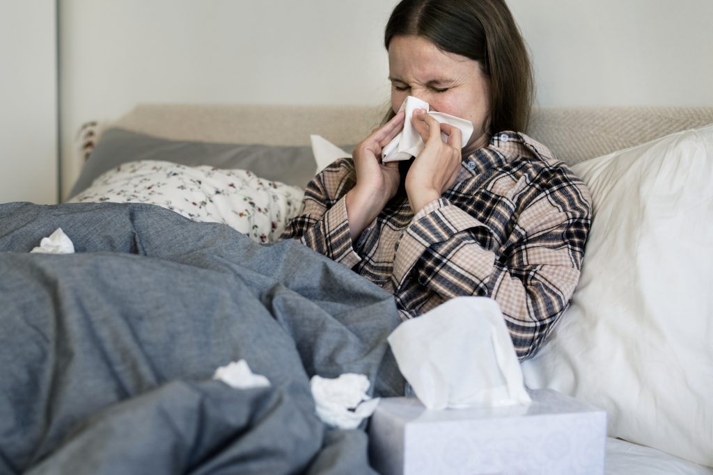 A Woman in bed with a cold