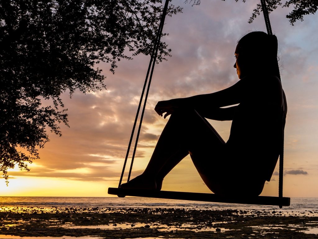 Woman on beach listening