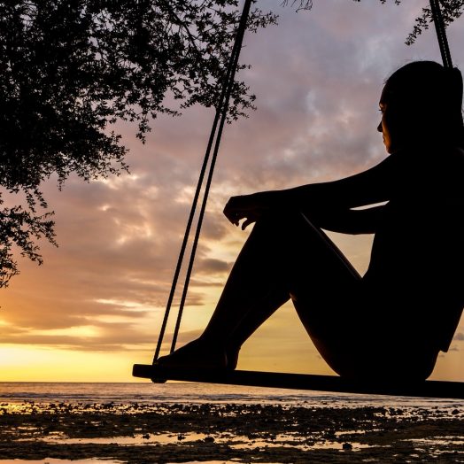Woman on beach listening