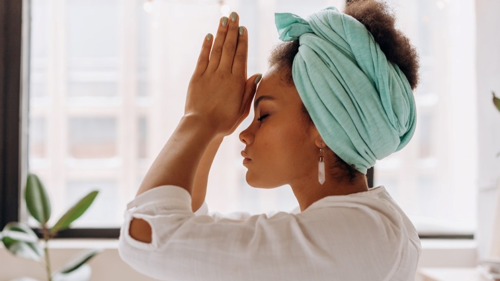 Woman holding hand to head for healing and growth