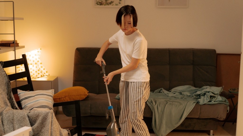 Woman Spring Cleaning in Living Room