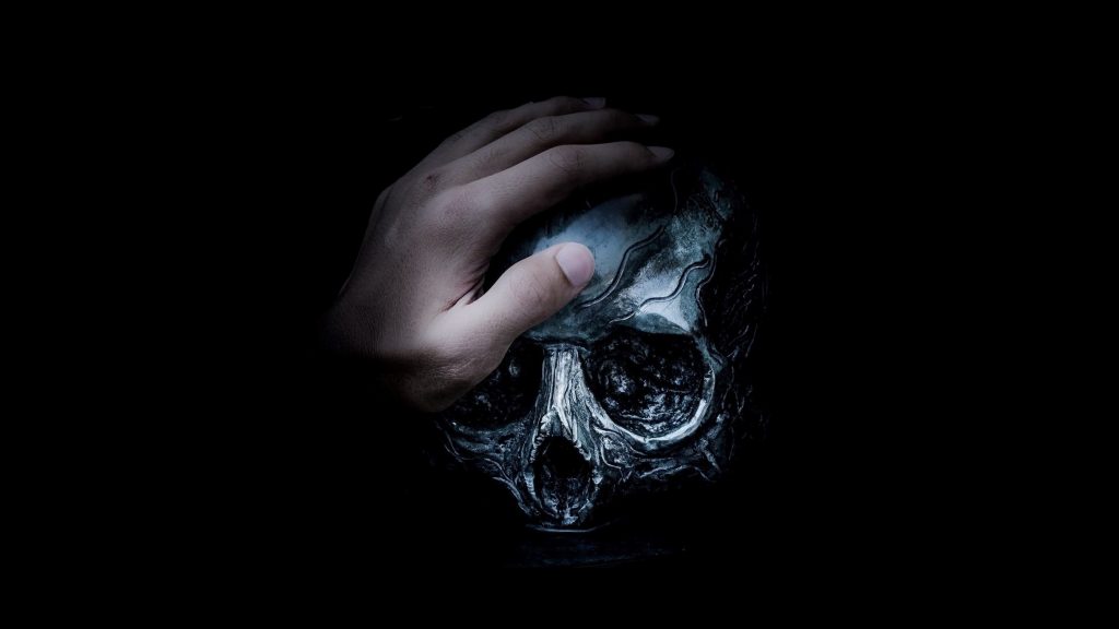 Friend of death, placing hand on skull