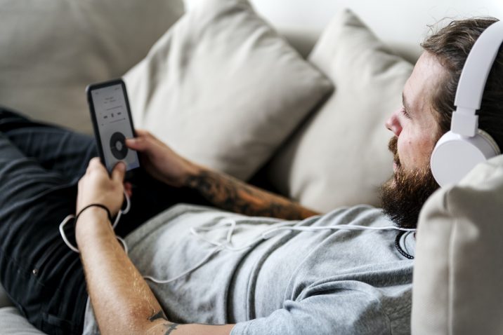 Man listening to music on couch