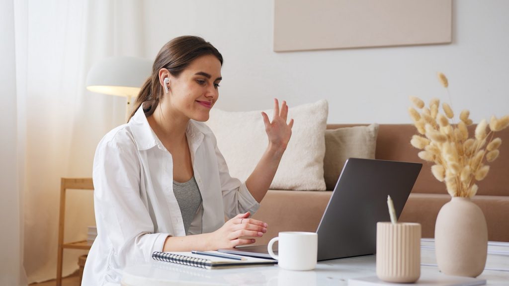 Woman sitting at a computer smiling