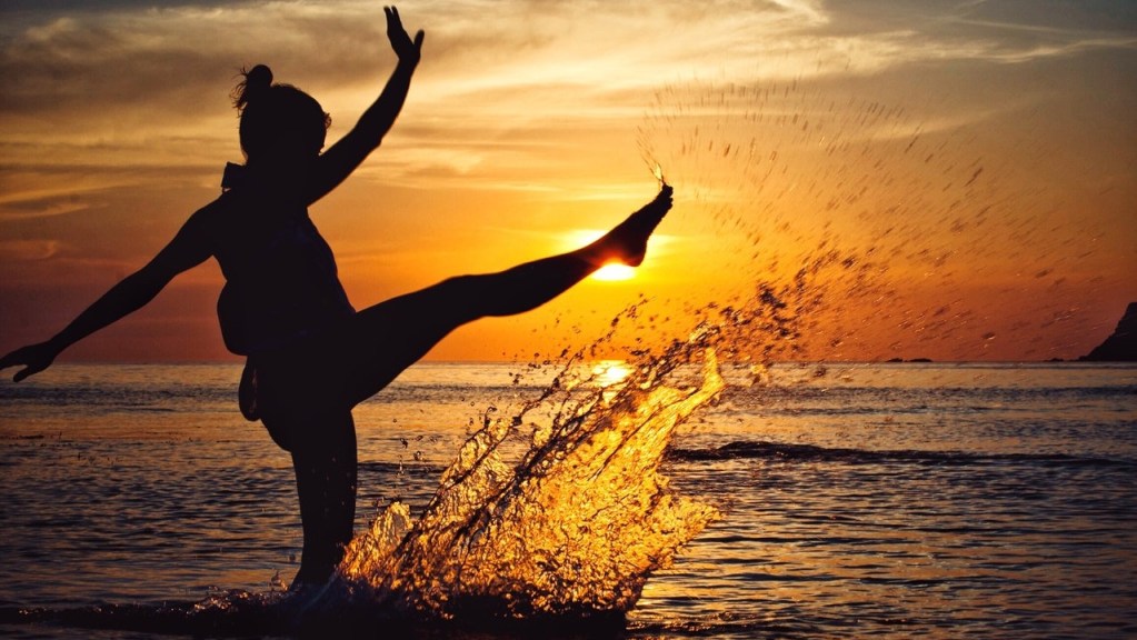 Joyful detached woman on beach