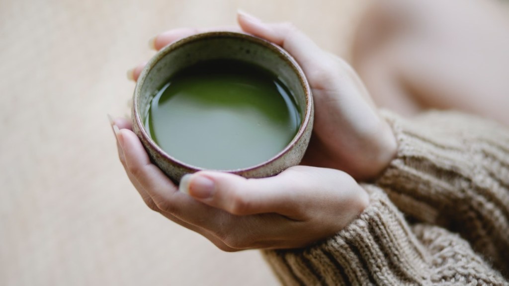 Woman drinking green tea for breast health