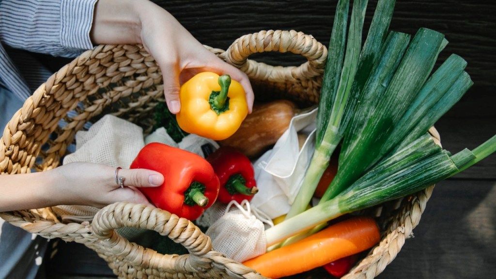 Woman adding enlightened vegetables to in a basket