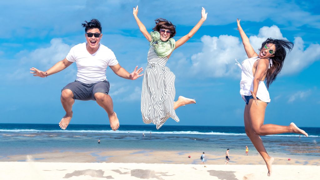 Friends on beach enjoying summer