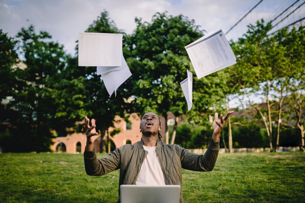 Man throwing papers in the air
