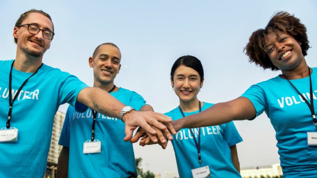 Group of volunteers holding hands