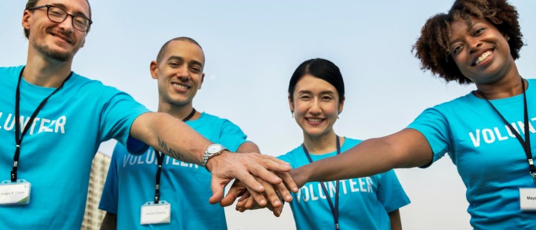 Group of volunteers holding hands