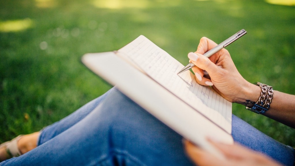 Woman writing in a book