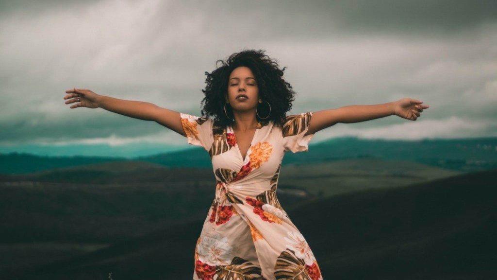 Woman with arms outstretched feeling content and happy