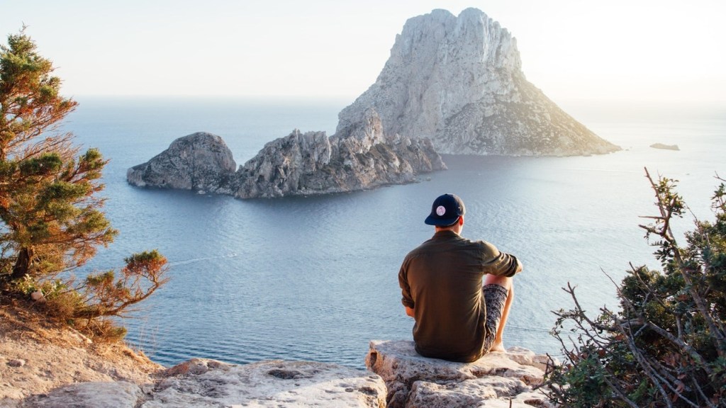 Man overlooking view the ocean, enjoying a spiritual vacation