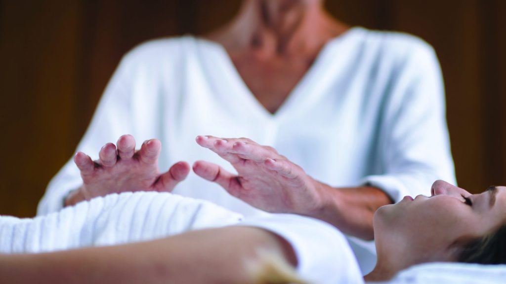 Woman receiving Reiki therapy