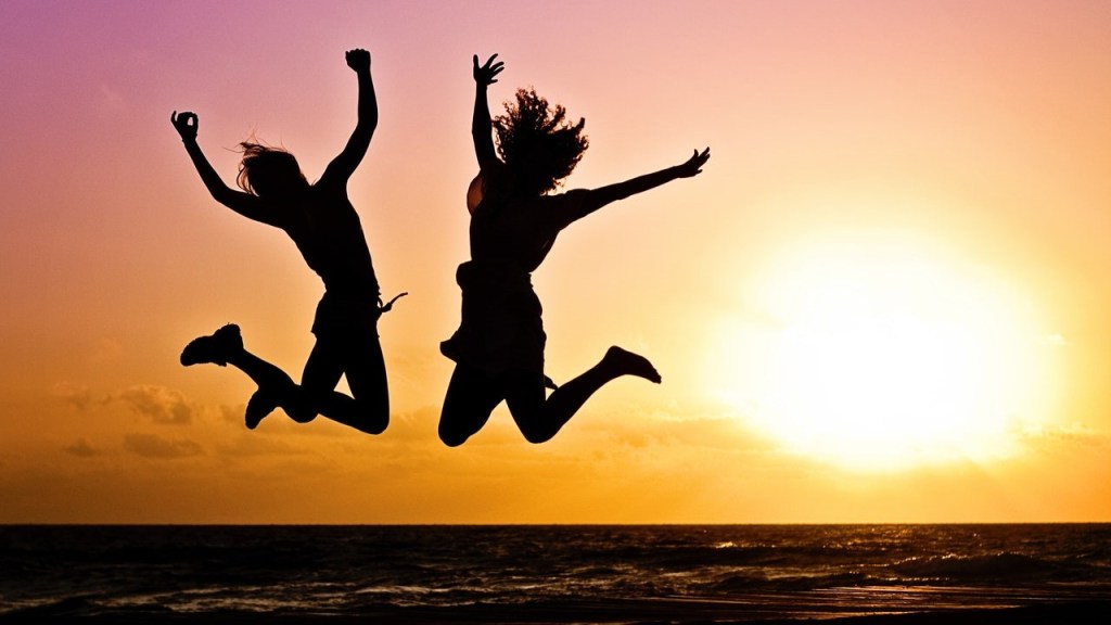 Jumping at sunset celebrating inner wealth