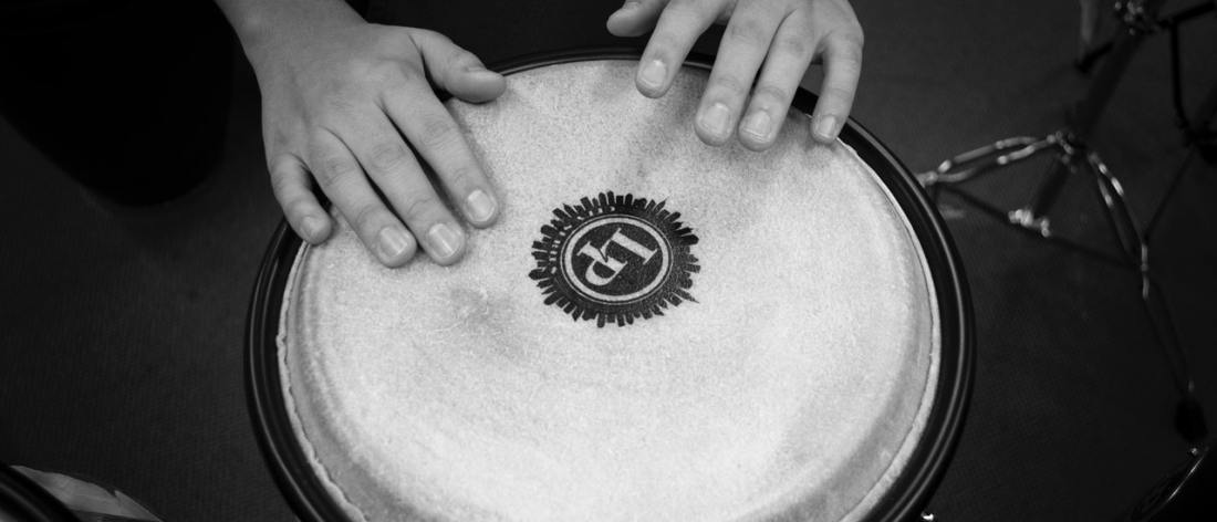 Hands with rhythm beating on a drum