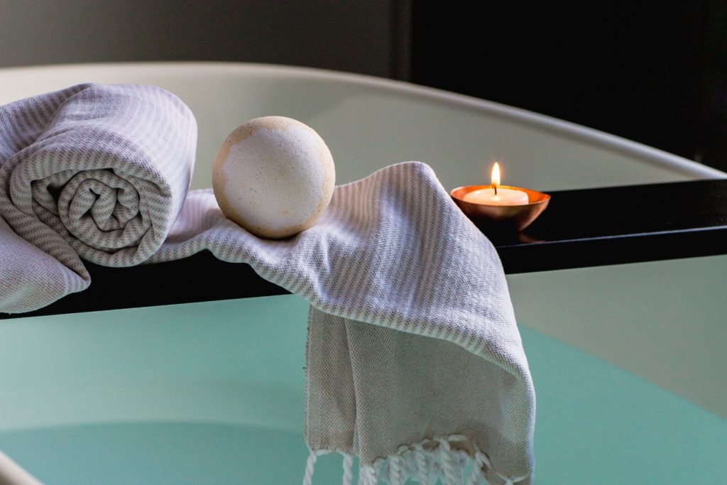 Bathtub with candle and bath salts
