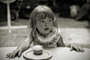 Girl about to eat a cupcake