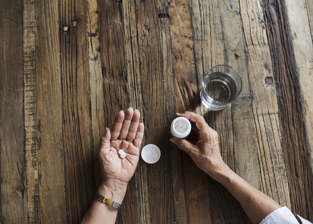 A woman taking a prescription painkiller