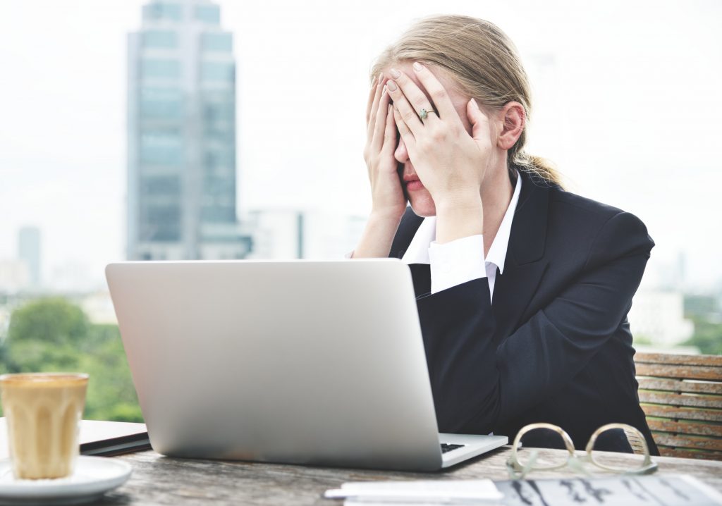 Overwhelmed woman at her computer
