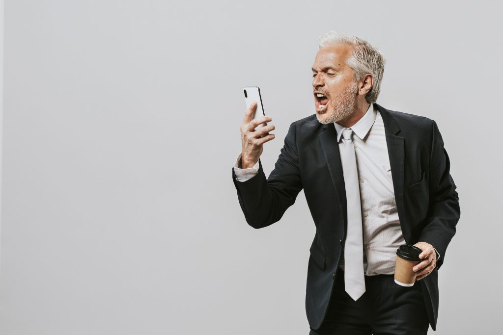 Man screaming into his cell phone