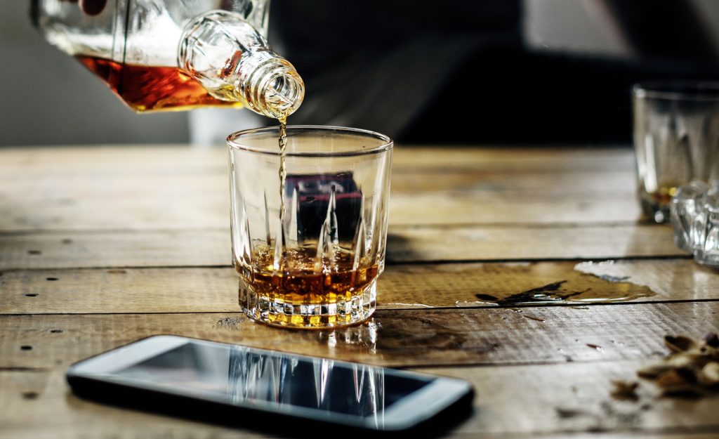Someone pouring a scotch - a drink too many