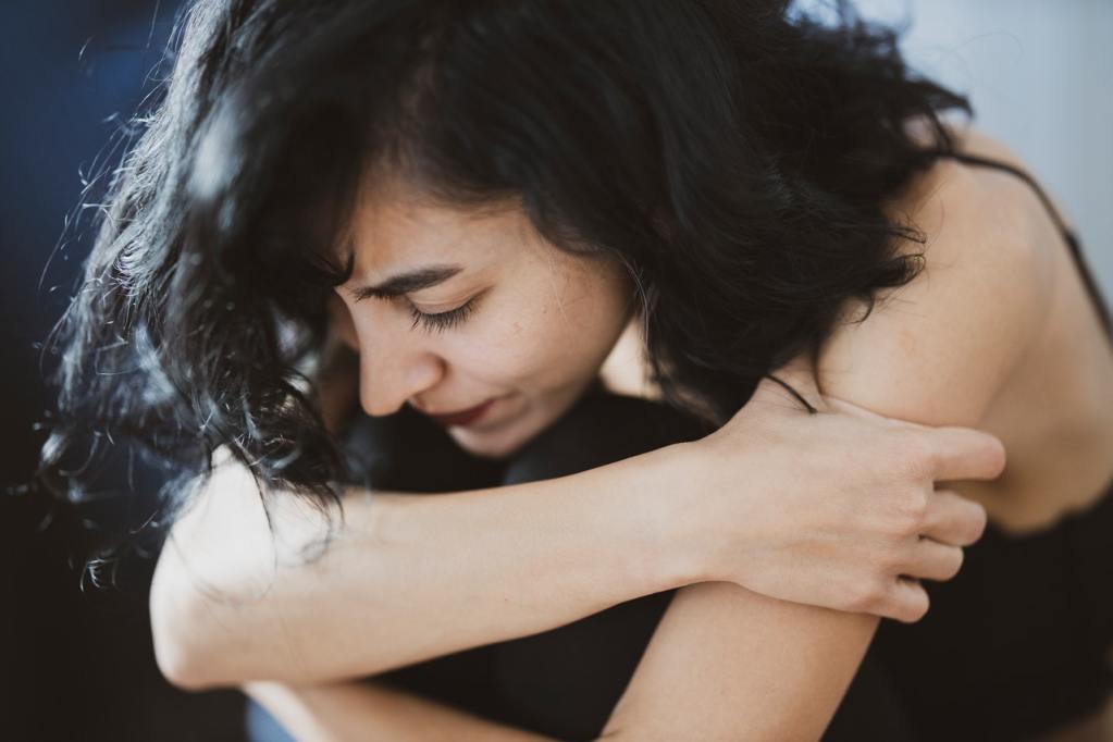 Woman feeling fatigue and holding arms