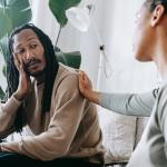 Woman with her hand on a man's shoulder - Traits of an Empath