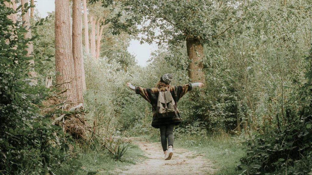 Woman walking on a path, experiencing well being