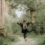 Woman walking on a path, experiencing well being