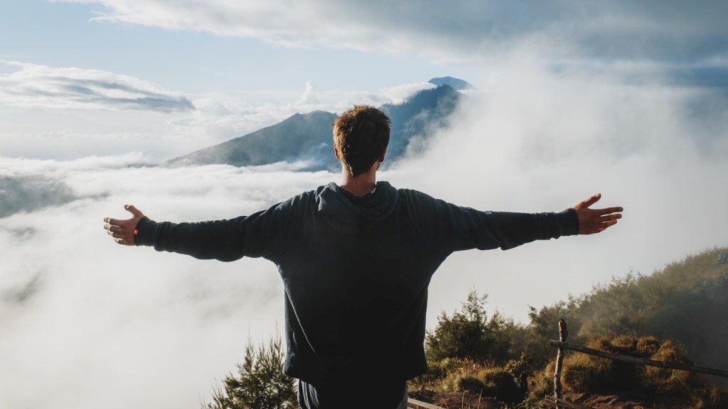 Man on mountain glimpses beyond normal life