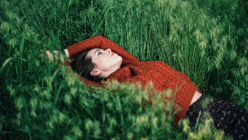 Woman daydreaming in a field