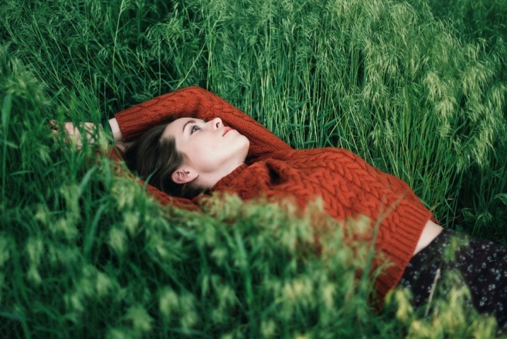 Woman daydreaming in a field